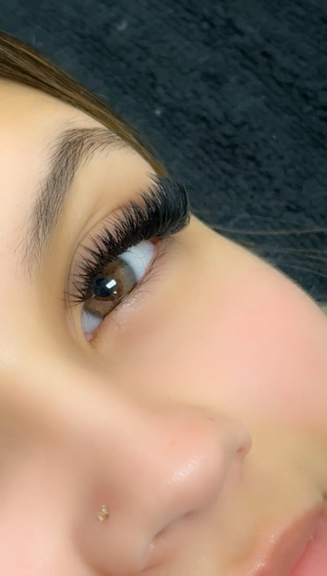 Close-up profile of a wispy volume lash set